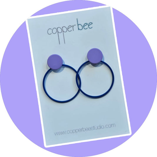 Minimalist colourful powder-coated brass circle and dot stud earrings by Copper Bee. Lightweight hypoallergenic stainless steel posts. Handmade UK jewellery.