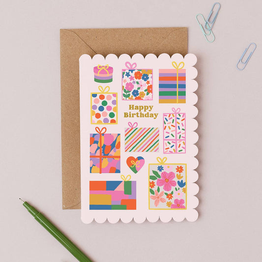 Gorgeous Gifts Birthday Card featuring a stack of colourful presents with gold foil accents and scalloped edges