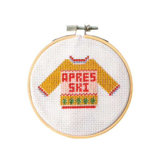 This Apres Ski Christmas Jumper Cross Stitch kit is a fab mini cross stich featuring a yellow winter jumper with Christmas trees across the bottom and the words APRES SKI across the centre of the jumper.