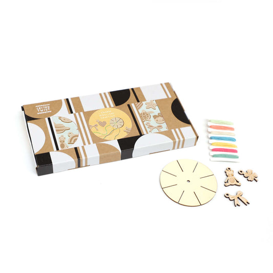 Close-up of wooden beads, charms, and thread spools from craft kit