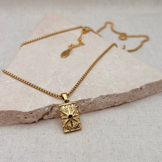 Little Nell Long Noir Rectangle Necklace with gold pendant and black star detail on adjustable 60cm chain.
