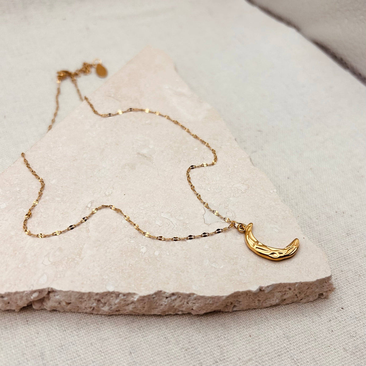 Model wearing the adjustable gold moon necklace