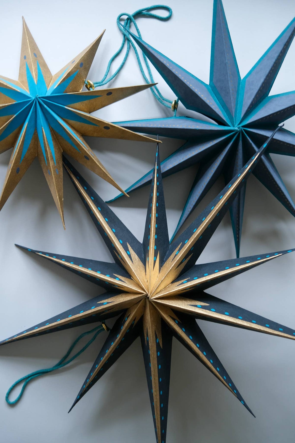 Handmade recycled paper star decoration showing 10cm hanging cord