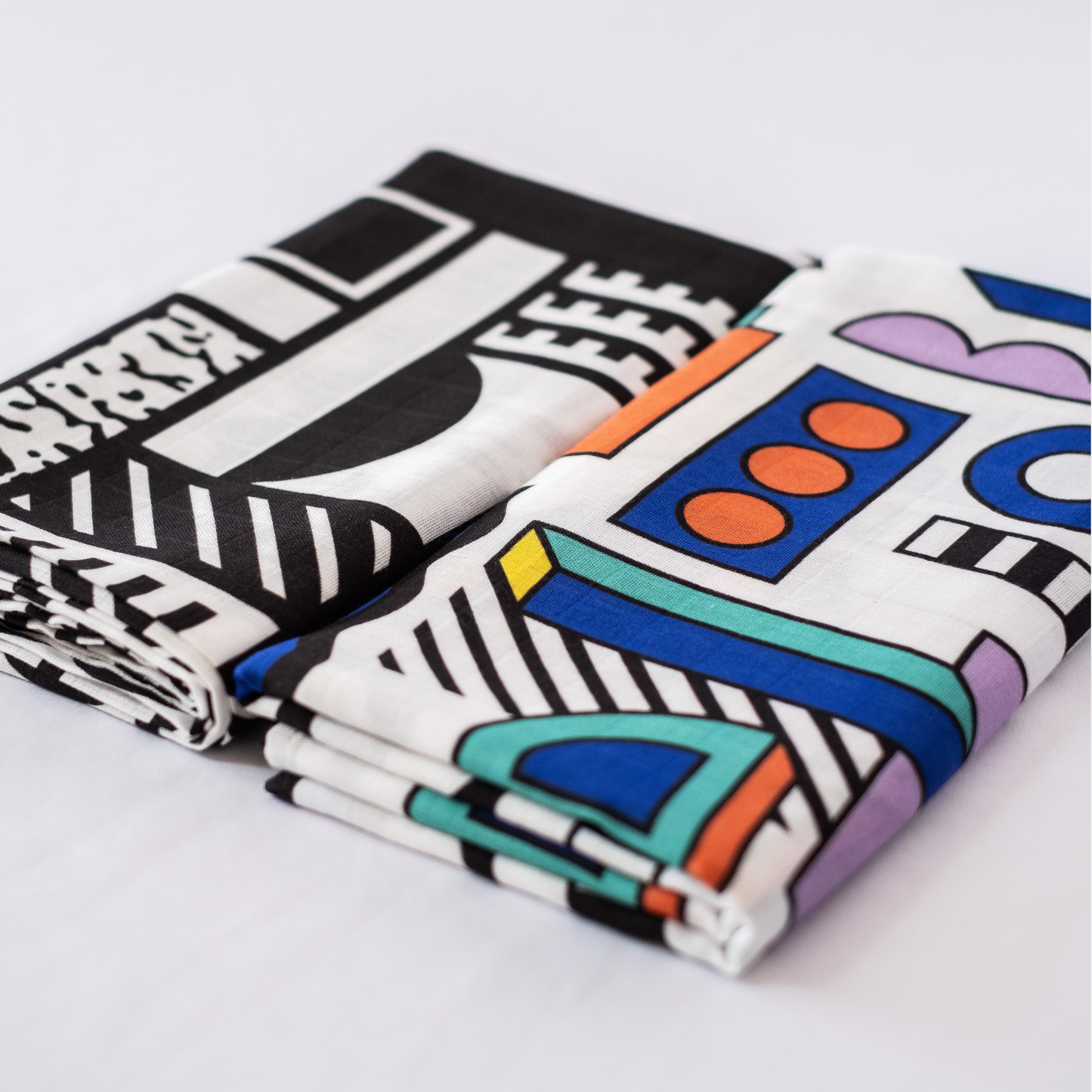 Pair of large sensory muslin squares featuring bold high-contrast designs by Camille Walala for Etta Loves, made from 100% organic cotton, suitable from 0–12 months.