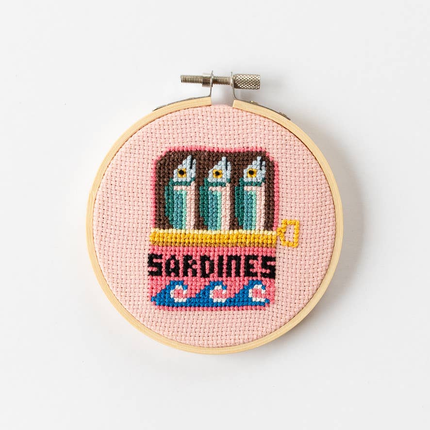 Sardines Cross Stitch Kit for beginners, featuring a 4-inch wooden hoop, coloured Aida fabric, embroidery thread, and eco-conscious packaging. Made in UK.