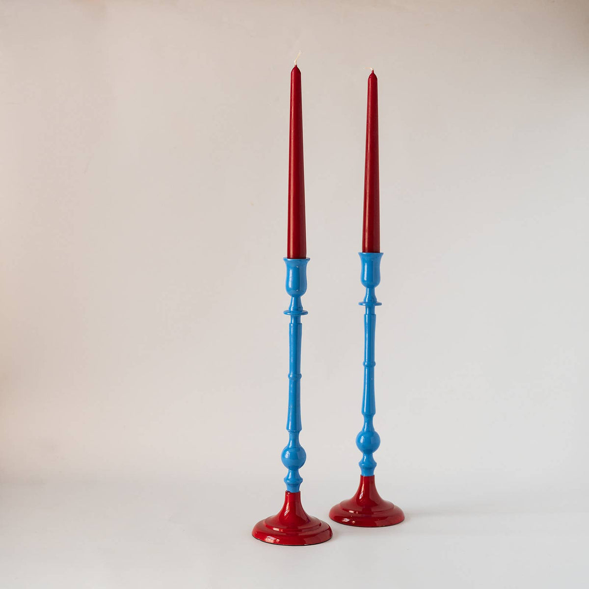 Garnet red and burnt orange enamel candlestick holder