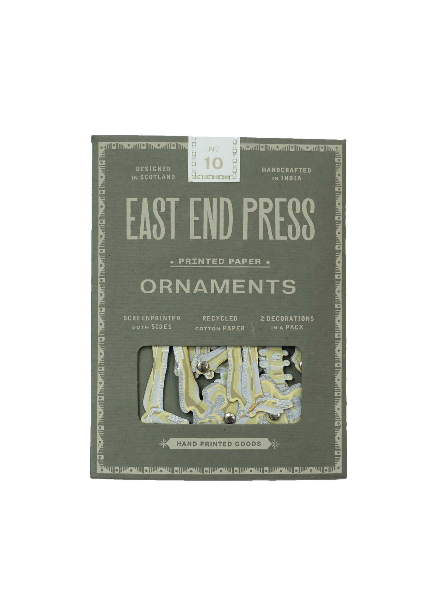 Detail shot of the recycled paper texture and hand-screen printed artwork on the dancing skeleton ornament.