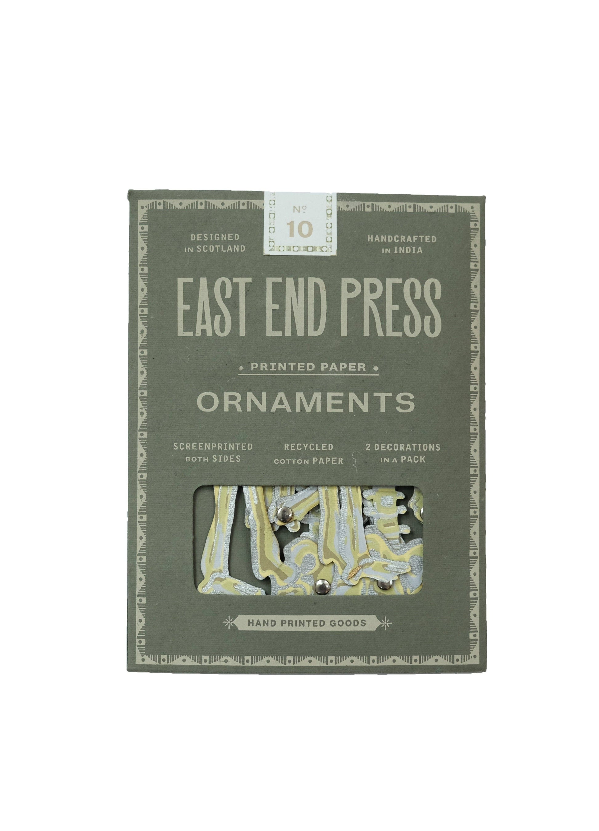 Detail shot of the recycled paper texture and hand-screen printed artwork on the dancing skeleton ornament.