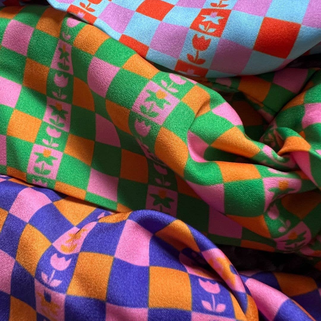 Close up of recycled plastic satin fabric on Caissa scrunchie