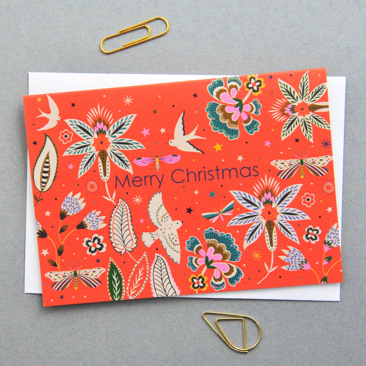 Christmas notecard with vibrant flora and fauna illustration on a red background, 'Merry Christmas' text.