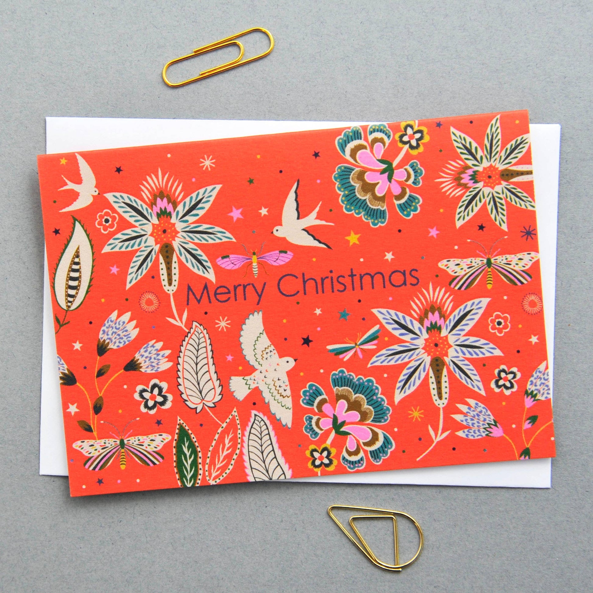 Christmas notecard with vibrant flora and fauna illustration on a red background, 'Merry Christmas' text.