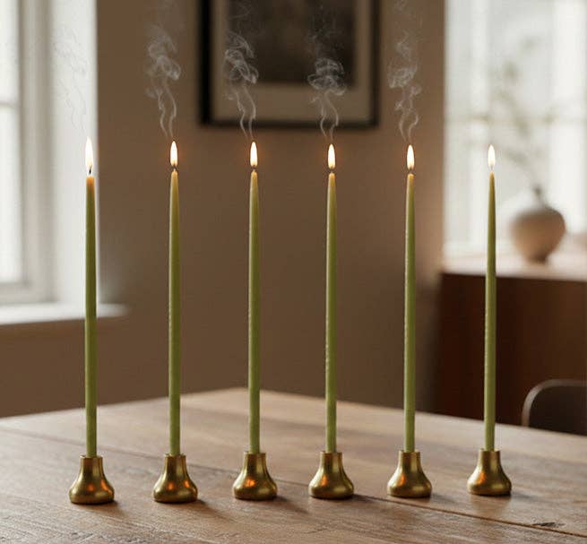 Set of six old gold thin taper candleholders on a styled dining table