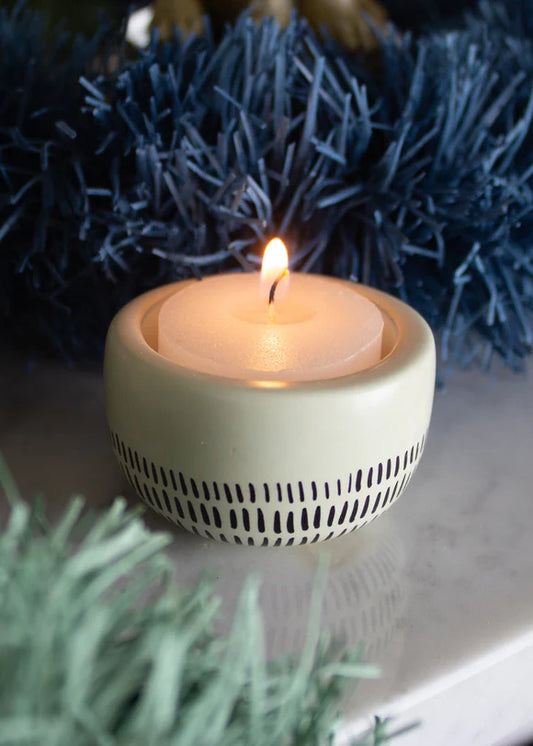 Kenyan Soapstone Tea Light Candle Holder 'Earth'. It has been crafted using ethically sourced material. The base has a smooth surface with walled edges, ideal for catching wax and keeping candles burning safely.