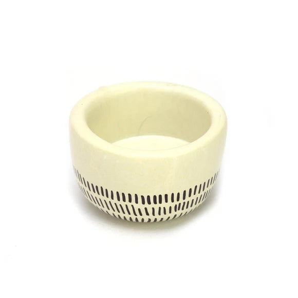 Kenyan Soapstone Tea Light Candle Holder 'Earth'. It has been crafted using ethically sourced material. The base has a smooth surface with walled edges, ideal for catching wax and keeping candles burning safely.