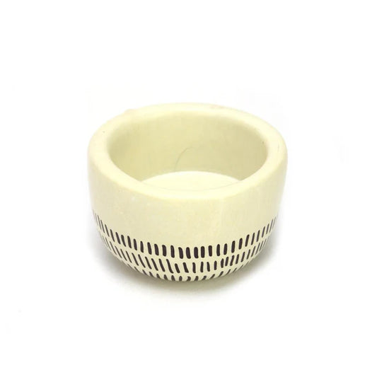 Close-up of 'Earth' soapstone tea light holder, showcasing the smooth beeswax finish and natural variations of the Kenyan carved stone.