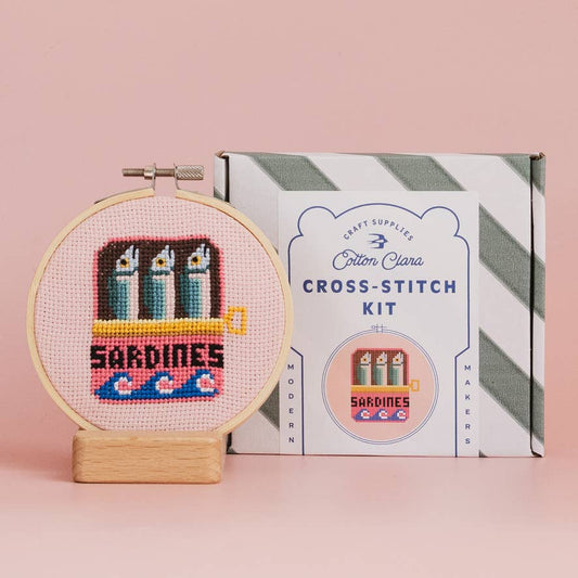 Sardines Cross Stitch Kit for beginners, featuring a 4-inch wooden hoop, coloured Aida fabric, embroidery thread, and eco-conscious packaging. Made in UK.