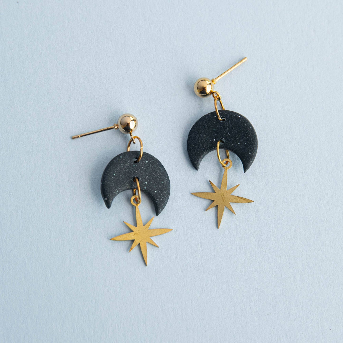 Model wearing Midnight Black Celestial Gold Star Drop Earrings, showcasing elegant design and size.