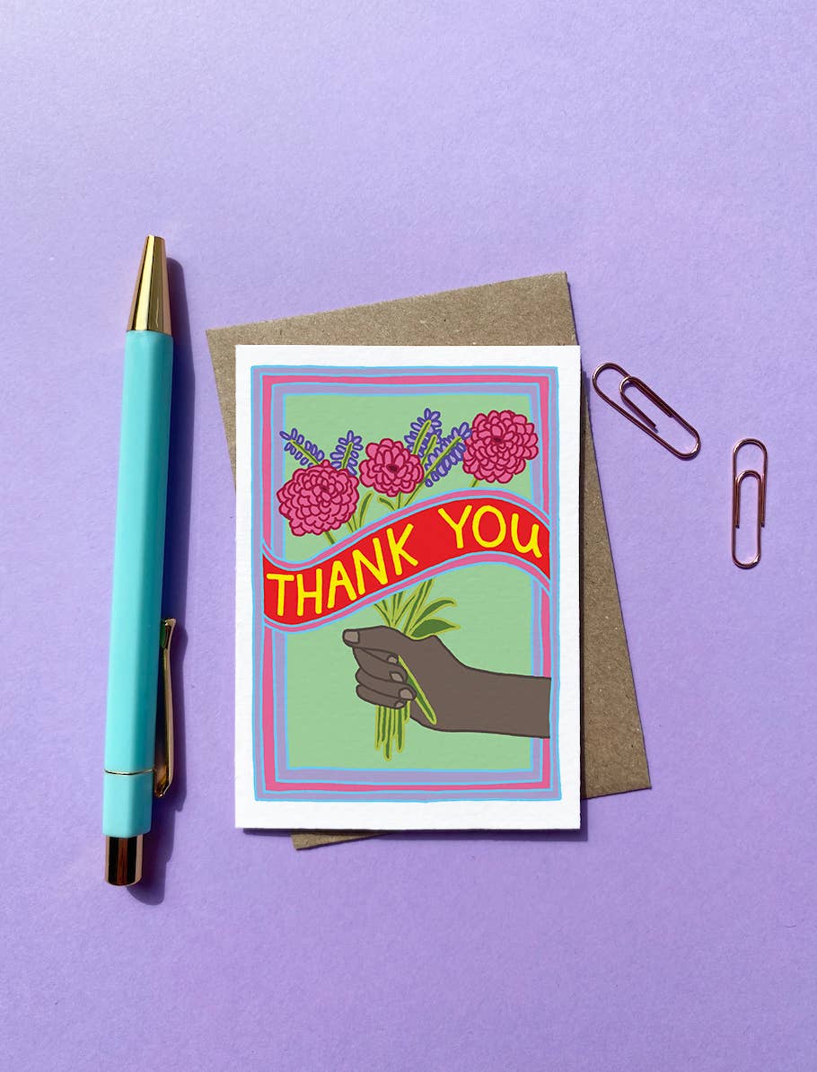 Mini Thank you Card. Thank You! Featuring a hand and a colourful bunch of flowers. With the words THANK YOU across the middle of the card in bold yellow writing.