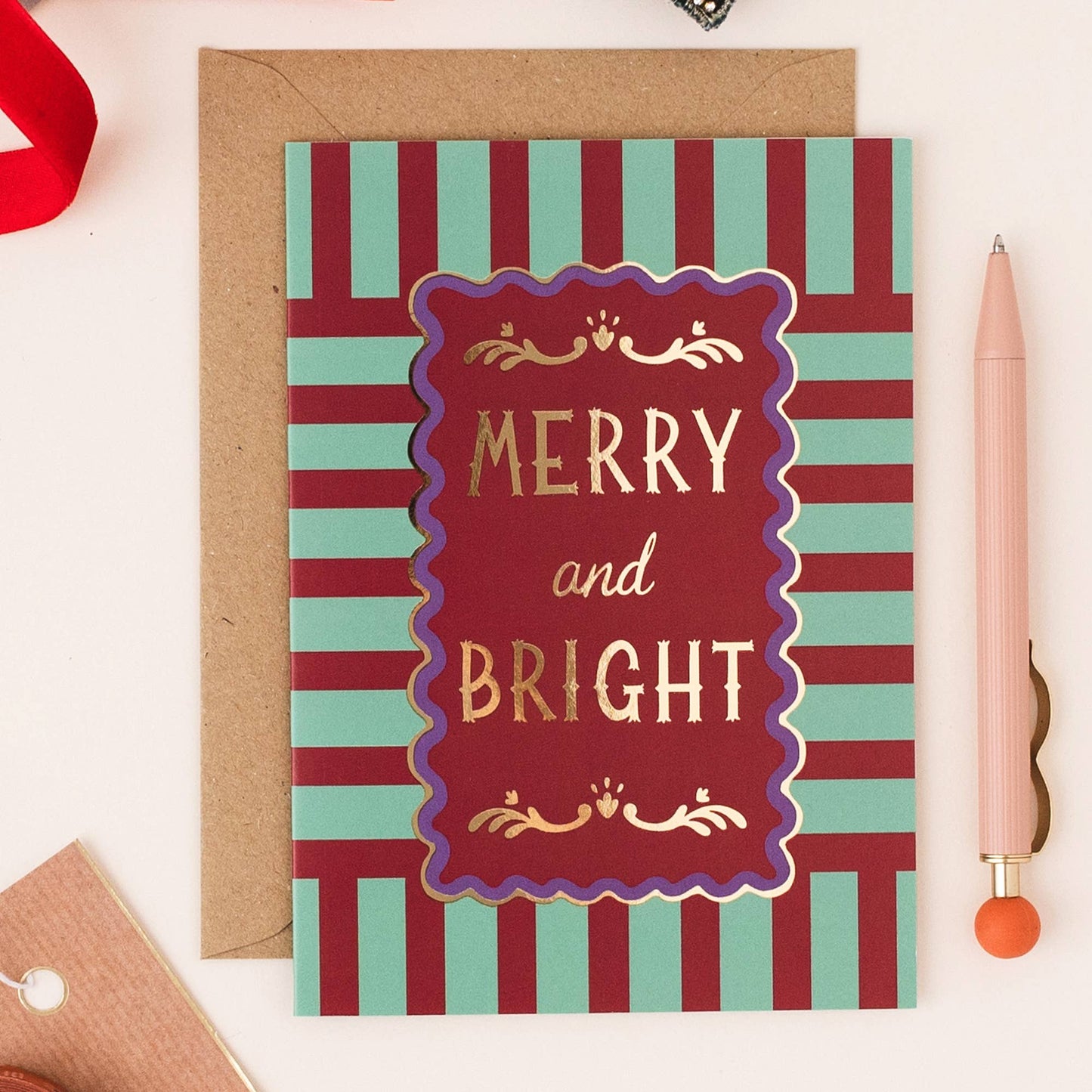 Close-up of Modern Stripe Gold Foil Christmas Card showing 'Merry and Bright' text and foil detail