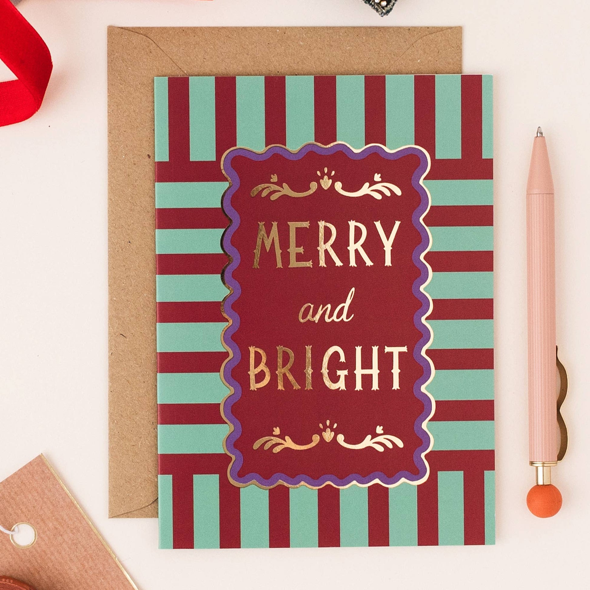 Close-up of Modern Stripe Gold Foil Christmas Card showing 'Merry and Bright' text and foil detail