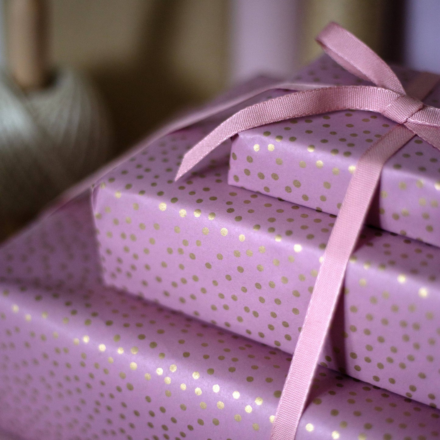 Pink kraft wrapping paper with gold dot design on a 5m roll