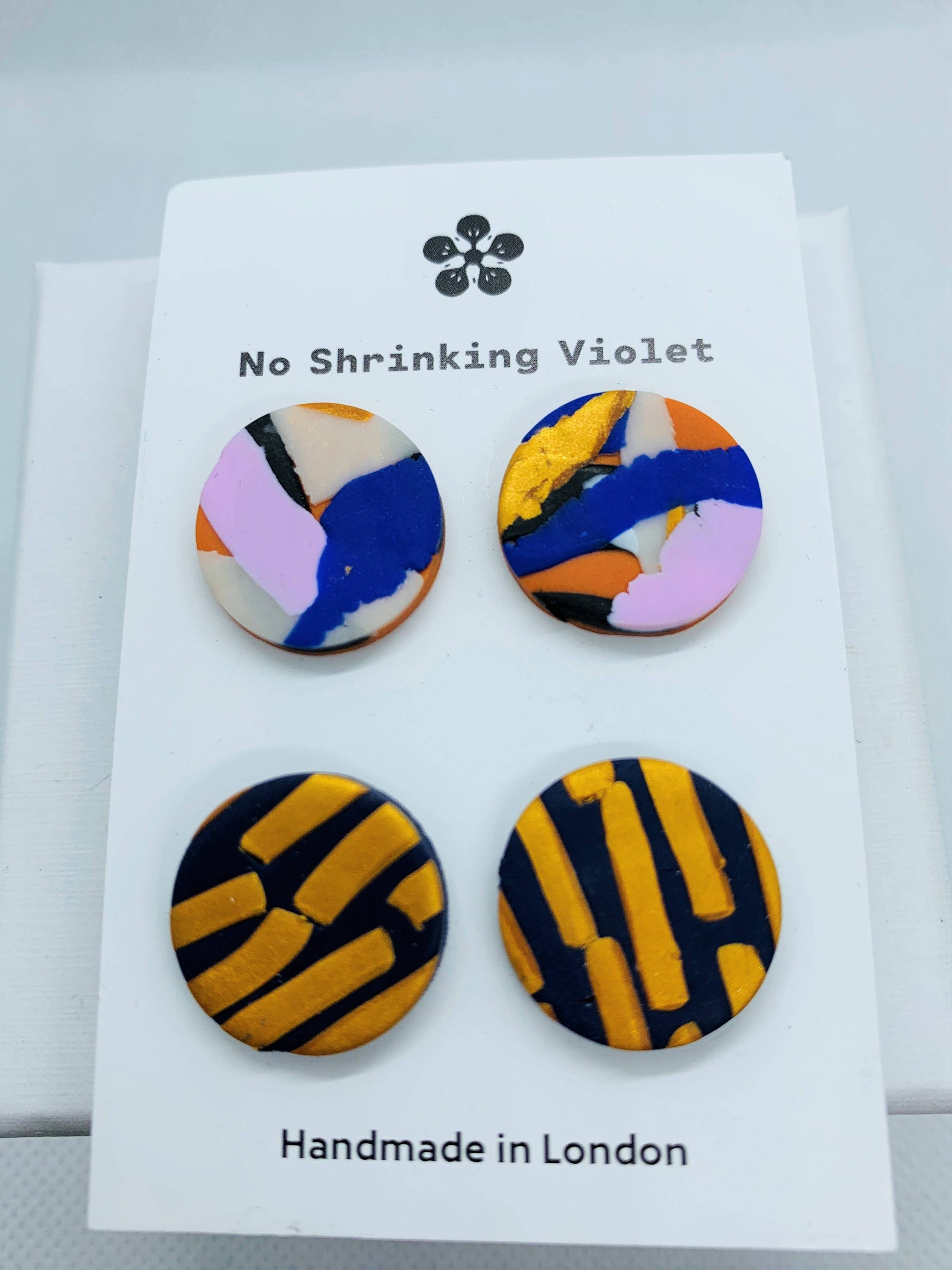 Set of two pairs of colourful polymer clay stud earrings with silver-plated hypoallergenic fixtures, 1.5cm each, handmade and vibrant."
Keyword Strategy:
- Primary: Polymer clay earrings, stud earring duo, handmade UK earrings, hypoallergenic stud earrings
- Secondary: colourful stud earrings, clay jewellery, silver-plated earrings, statement studs
Tags & Collections:
- Tags: Stud earrings, handmade jewellery, hypoallergenic, clay earrings, colourful accessories
- Collections: Everyday Jewellery, Statement 