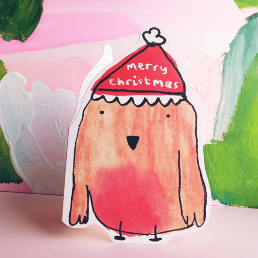 What's not to love about this jolly cut-out robin donning a holiday hat, spreading Christmas joy! With the words Merry Christmas on his red woolly hat.