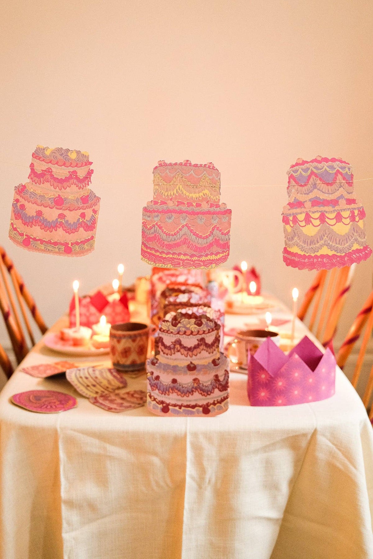 Celebration cakes garland hanging across mantelpiece