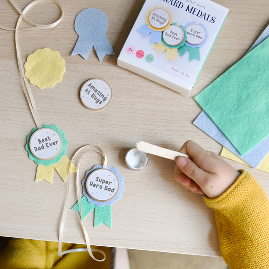 Craft Kit Make Your Own Medals for Dad. Make Dad three 'Best Dad' award medals for Father's Day. They're easy to make, and they're the perfect gift for your super Daddy.

The kids can make Dad a unique and personal Father's Day keepsake gift with this mini medals craft kit. It's completely plastic free and contains everything you need to make three medals, using wool felt and beech wood.

The 'awards' included in this craft kit are: • Super Hero Dad • Best Dad Ever • Amazing At Hugs
