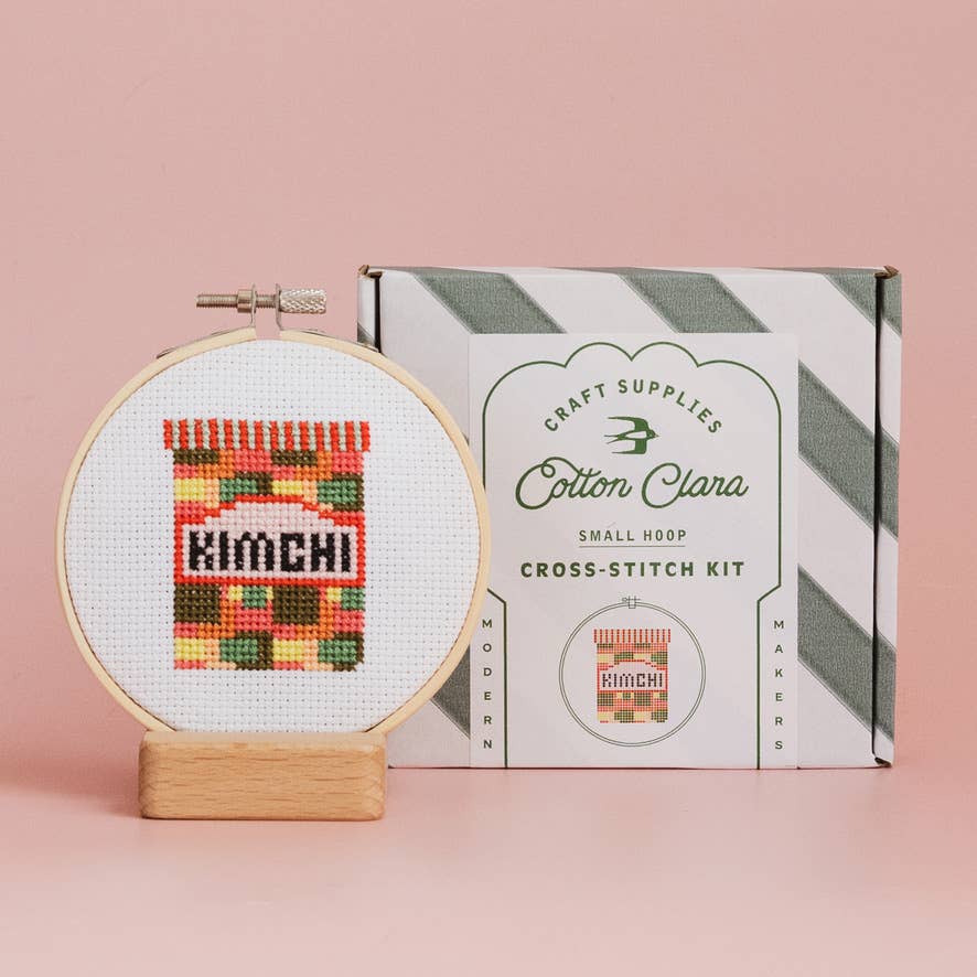 Kimchi Mini Cross Stitch Kit contents: 11cm wooden hoop, colourful Aida fabric, embroidery threads, blunt needle, wadding, and full-colour chart.