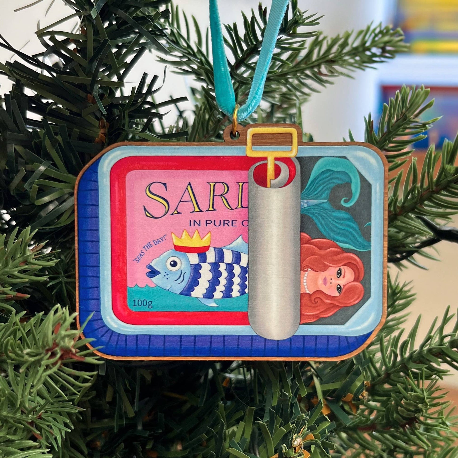 Sardine Tin Mermaid wooden Christmas tree decoration with Teddy & Kipling illustration, sustainably certified cherry wood, gold-plated ring, and turquoise velvet ribbon