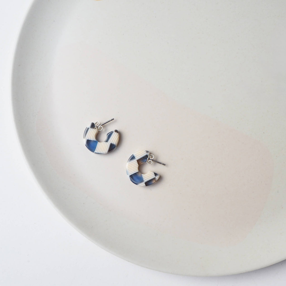 Side view of chunky ocean mix acetate hoop earrings