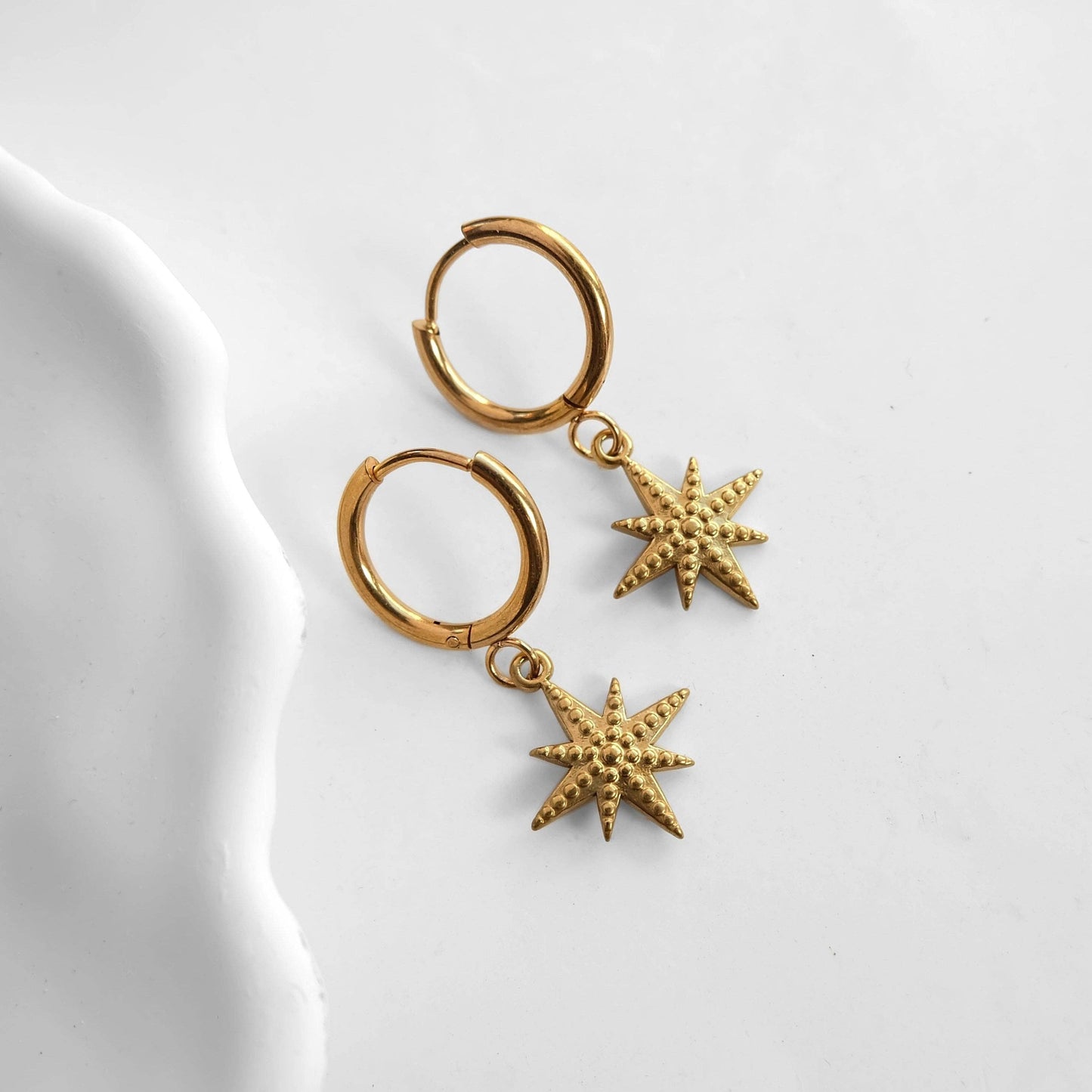 Zorya Star gold stainless steel hoop earrings with textured star charm