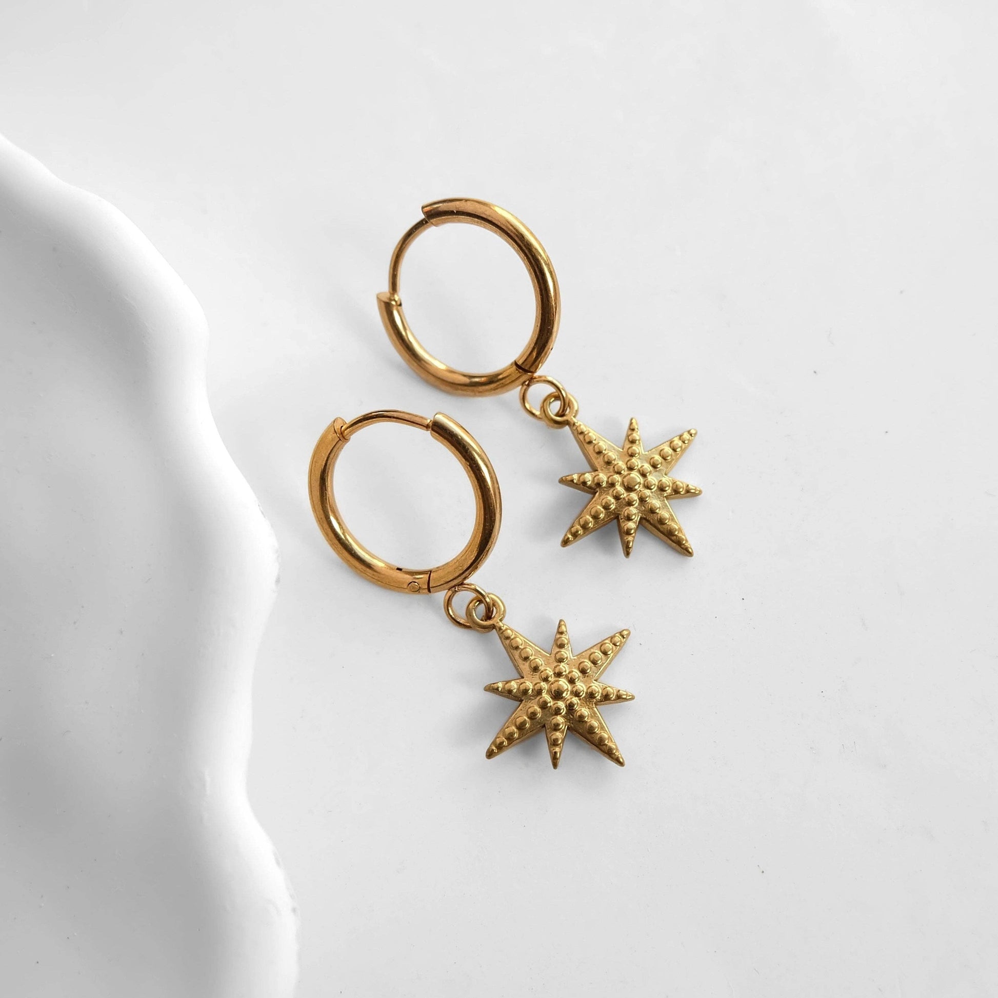 Zorya Star gold stainless steel hoop earrings with textured star charm
