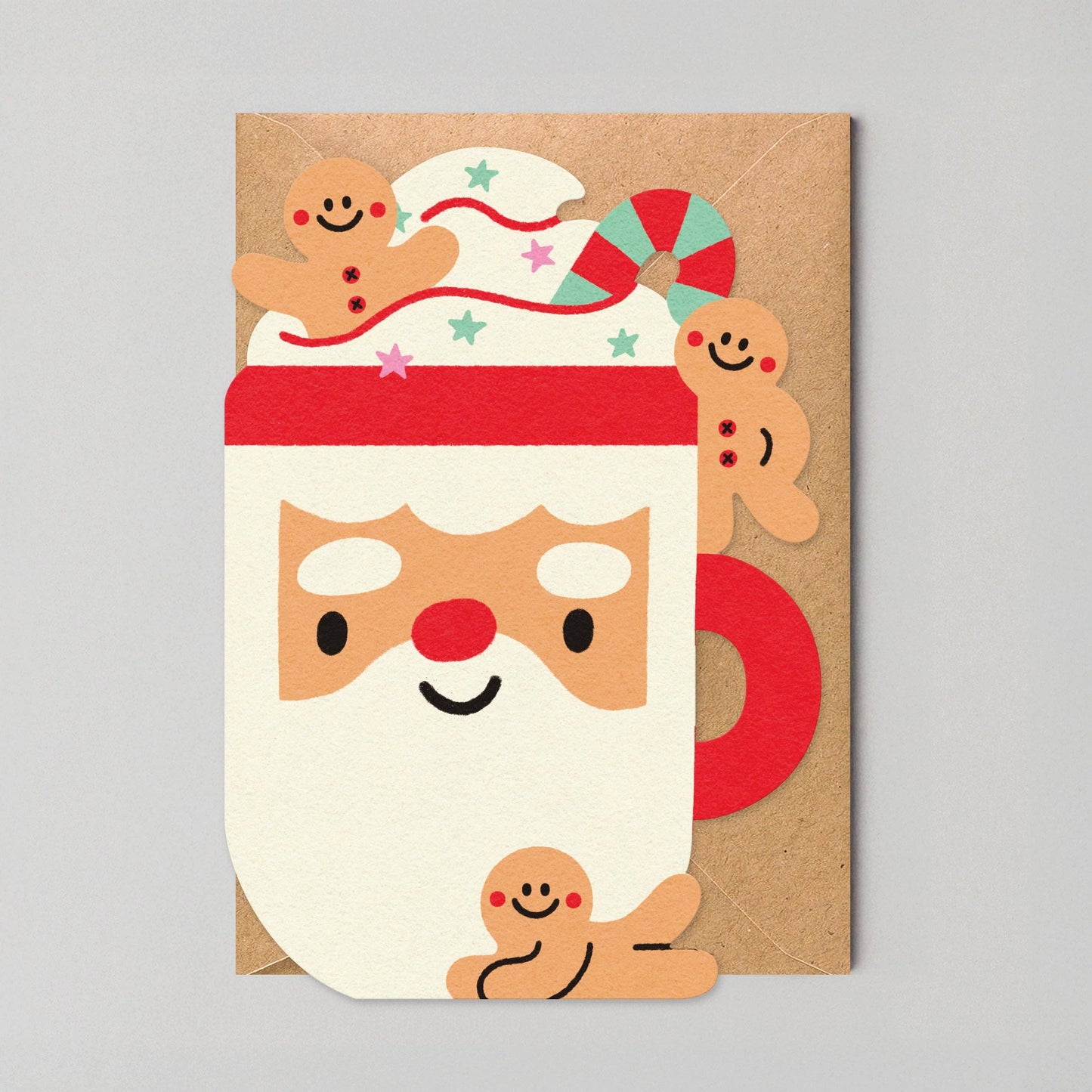 Charming die-cut Christmas card featuring a Santa mug overflowing with cream and gingerbread, designed by Edyta Demurat. Eco-friendly, plastic-free, blank inside, and made in the UK.