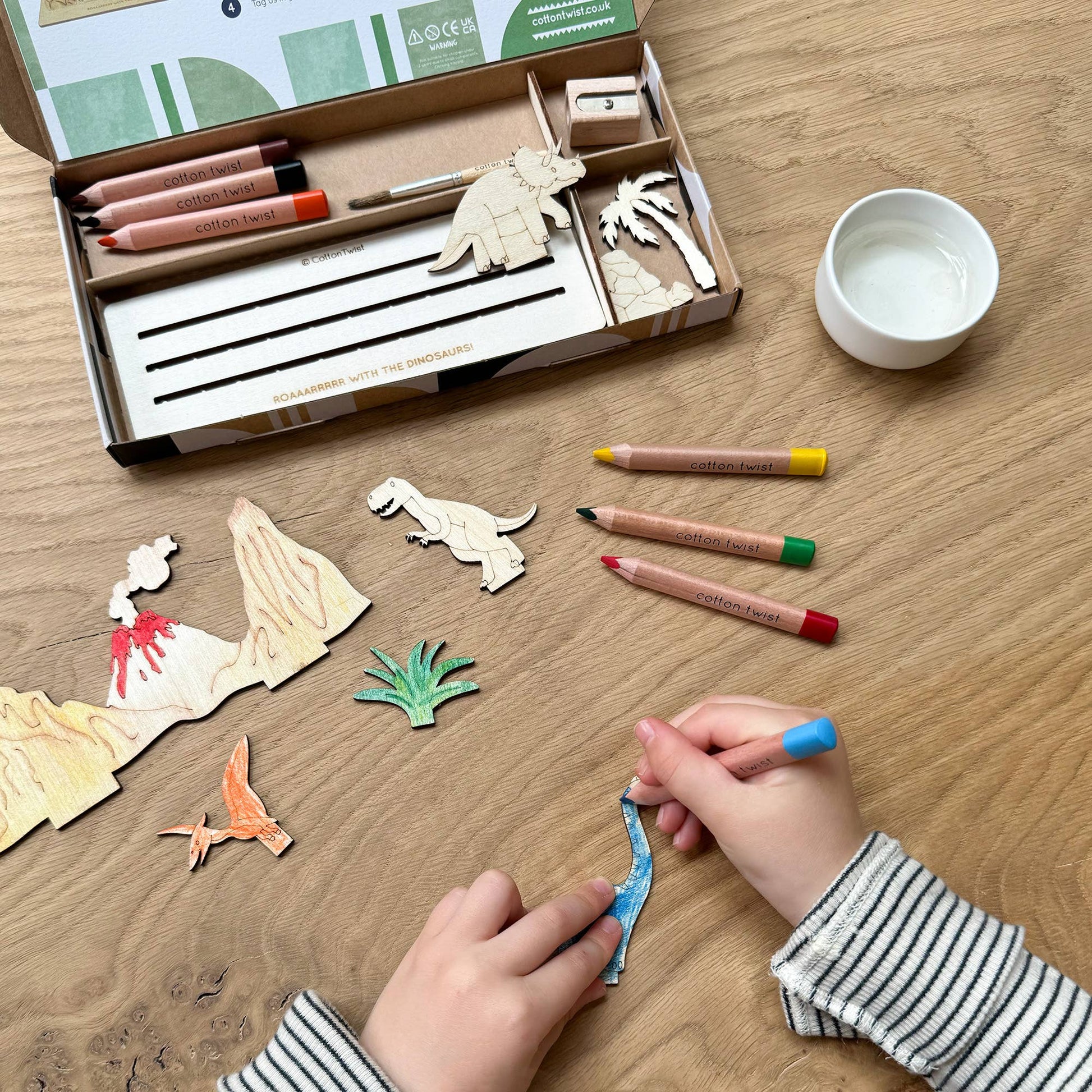 This craft kit is perfect for those who love to be creative, those who love dinosaurs (who doesn't!). Inside, discover a collection of wooden pieces, each intricately designed to spark creativity, including the mighty T-Rex, a triceratops, pterodactyl and a brachiosaurus. With wooden parts of all your favourite dinosaurs, plus scenery, the watercolour pencils &amp; paintbrush included allow for detailed ; precise painting with the ability to mix colours. Once painted, simply add the wooden parts 