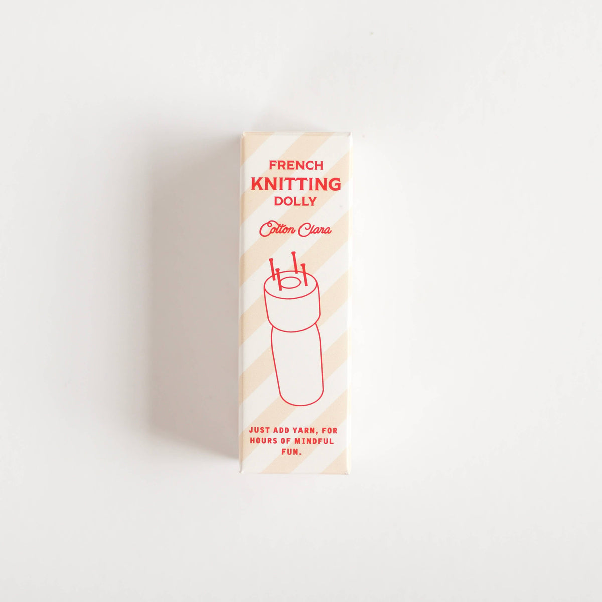 French knitting kit contents on a neutral background
