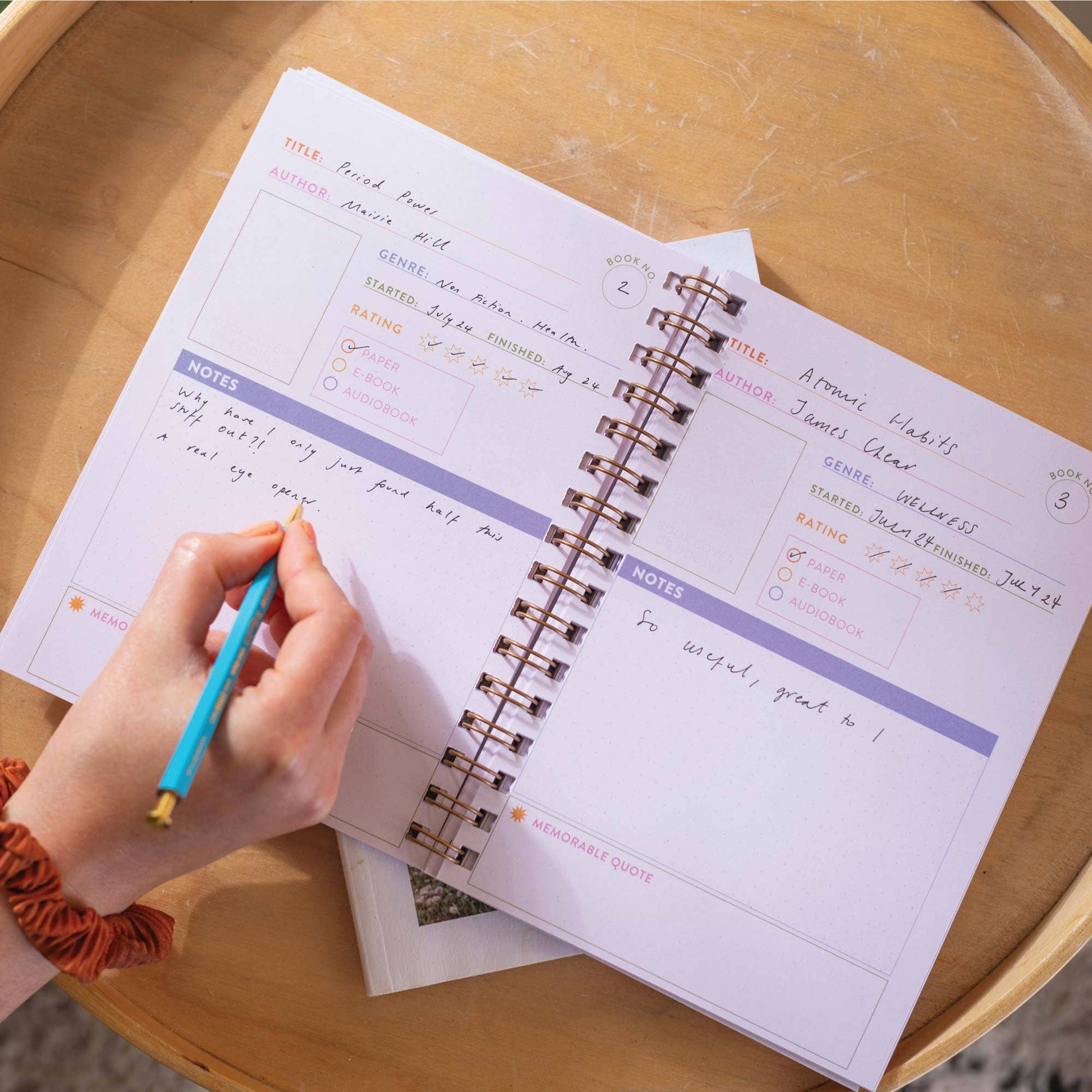 A5 Book Nook Reading Journal open to a book log page, featuring colourful illustrations