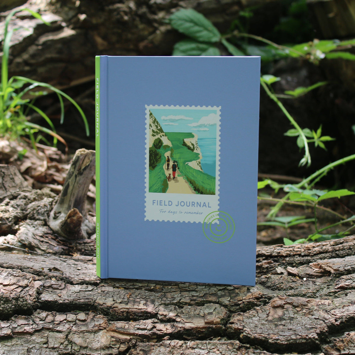 Hiking Field Journal open on a table with scrapbooking memorabilia
