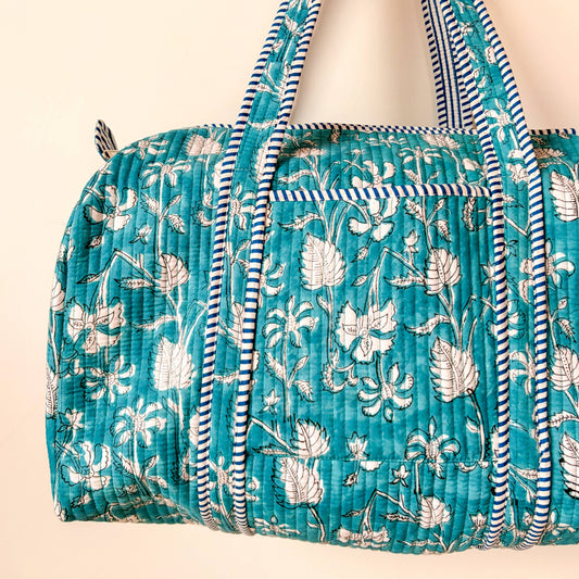 Close up of quilted fabric and stripe trim on cotton weekend bag