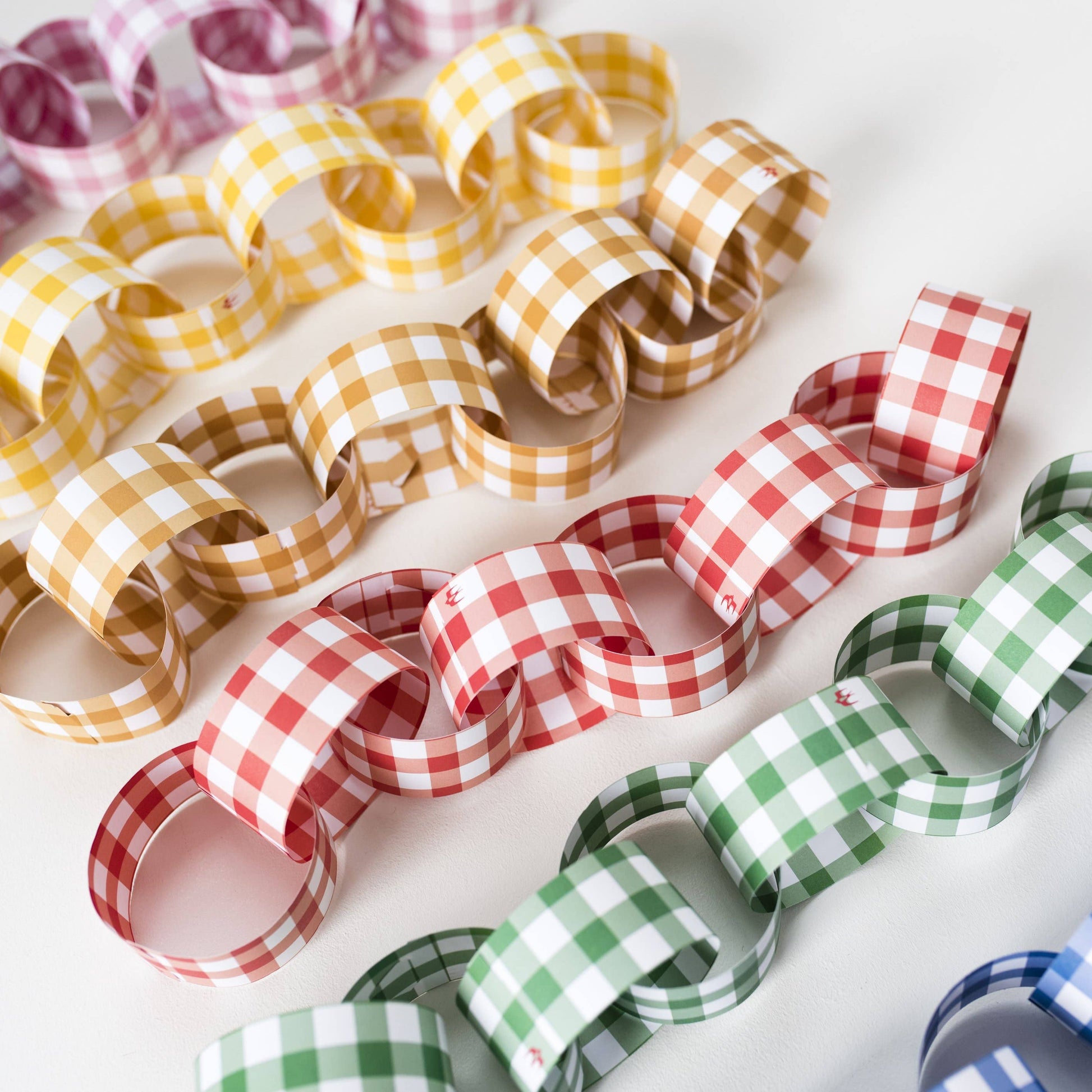 Festive gingham reusable paper chain kit with 48 pre-cut strips in assorted colours, no glue or tape needed, packaged in recyclable UK-made envelope