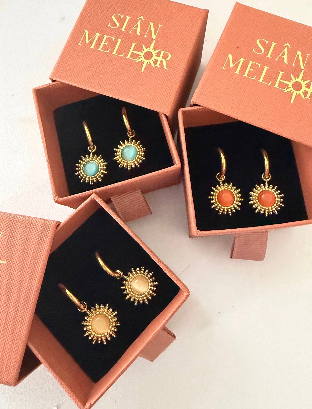18k gold plated sun hoop earrings in pink, blue, and white