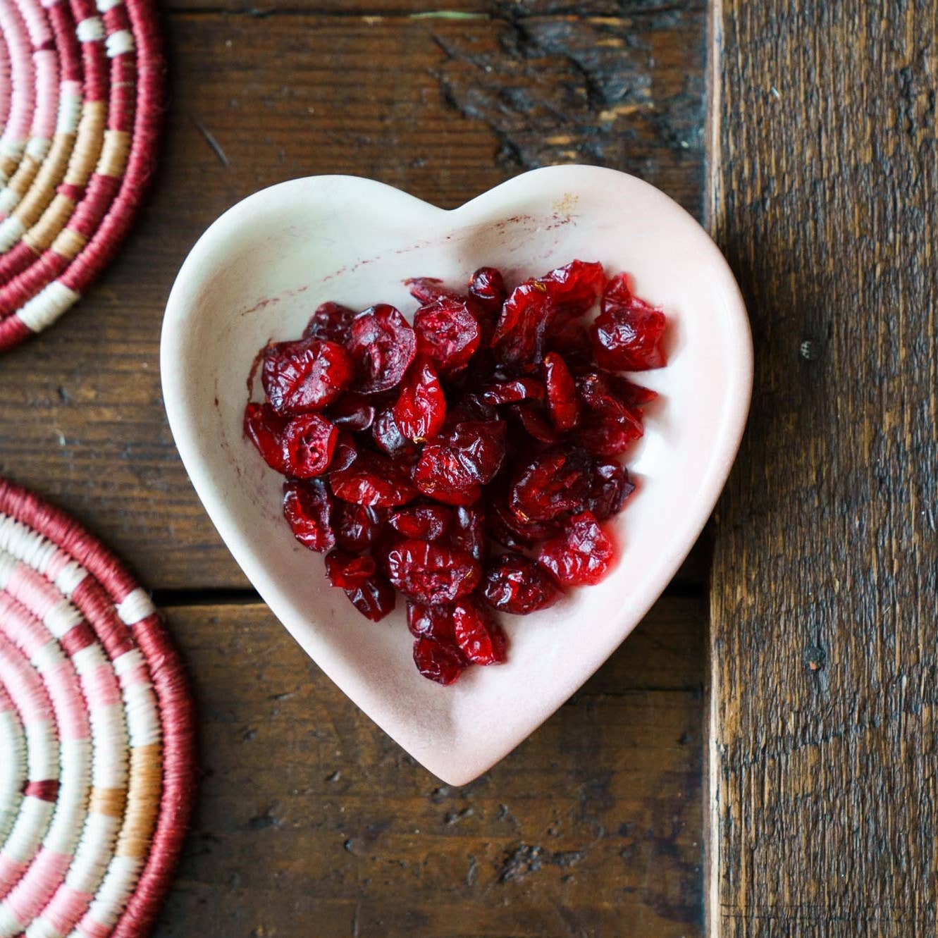 Heart Shape Soapstone Trinket Dishes. In ivory shown filled with dry cranberries