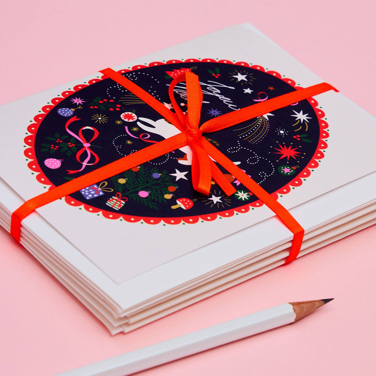 Close up of illustrated festive cat Christmas card on midnight blue background