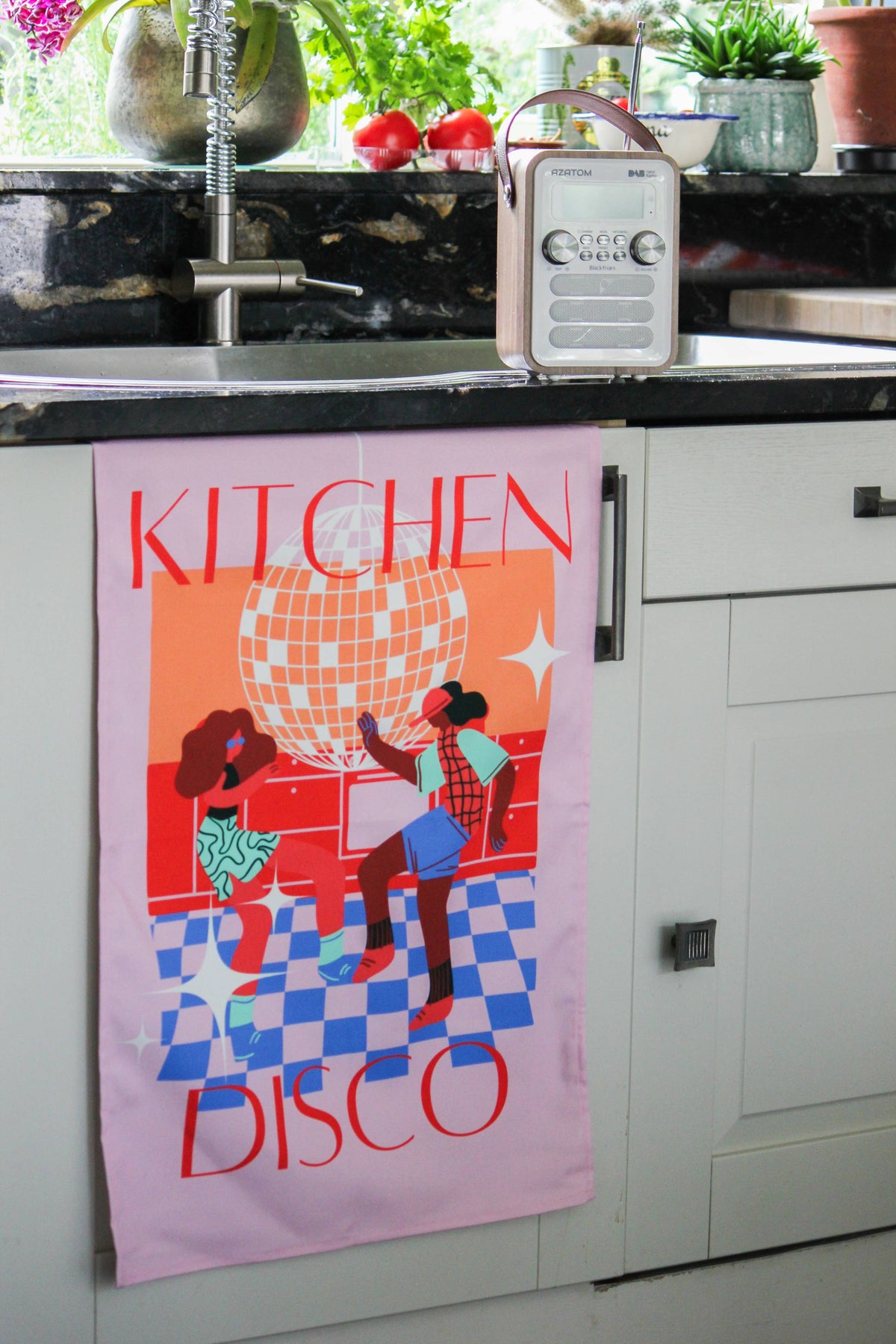 Close up of colourful checkered disco tea towel with diverse characters