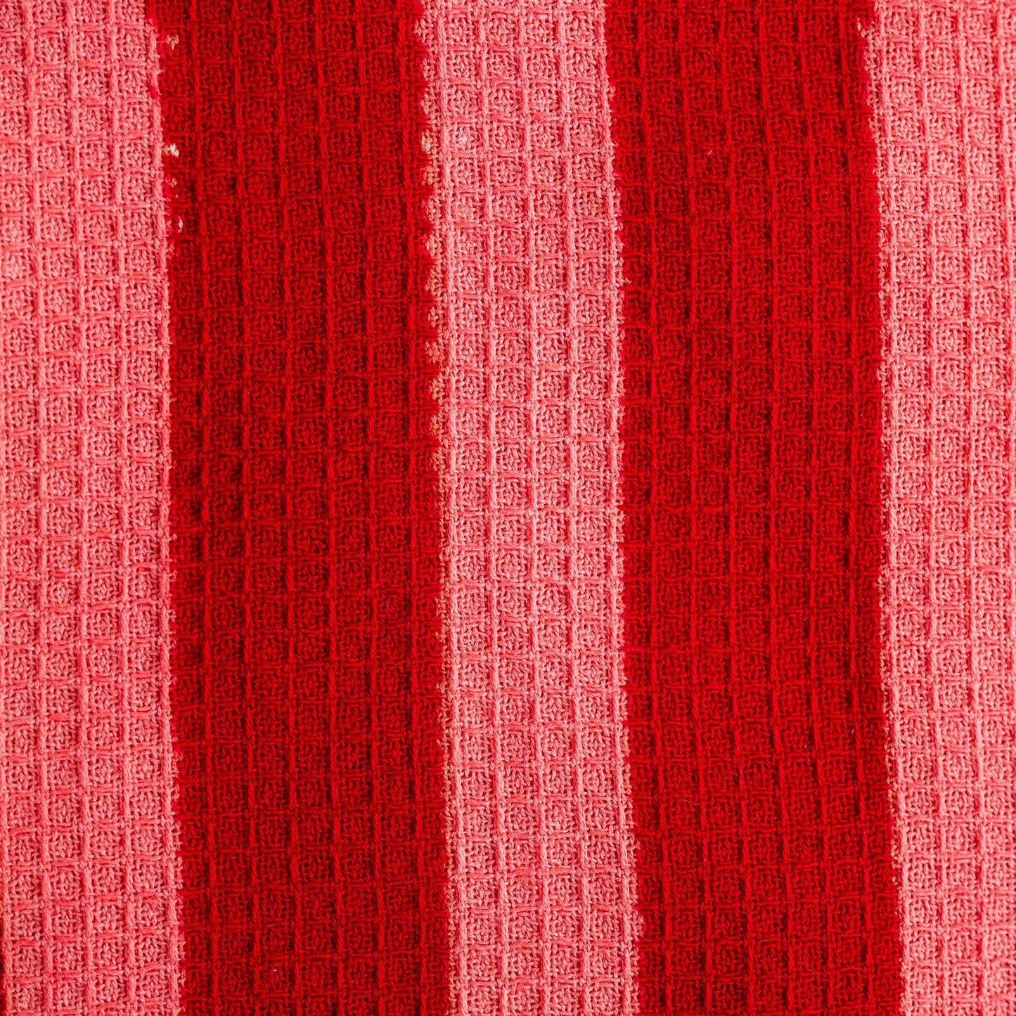 Close up of hand-block printed crimson stripe tea towel