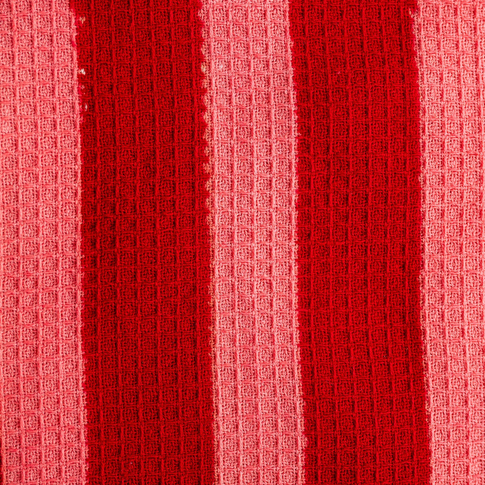 Close up of hand-block printed crimson stripe tea towel