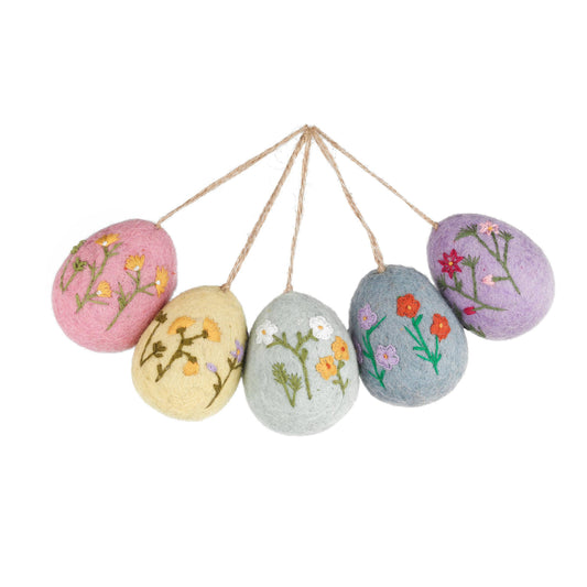 Elevate your Easter decor with these exquisite hand embroidered felt eggs featuring delicate floral embroidery. Each egg is meticulously hand stitched, showcasing intricate details and vibrant colours that will add a touch of elegance to your home.