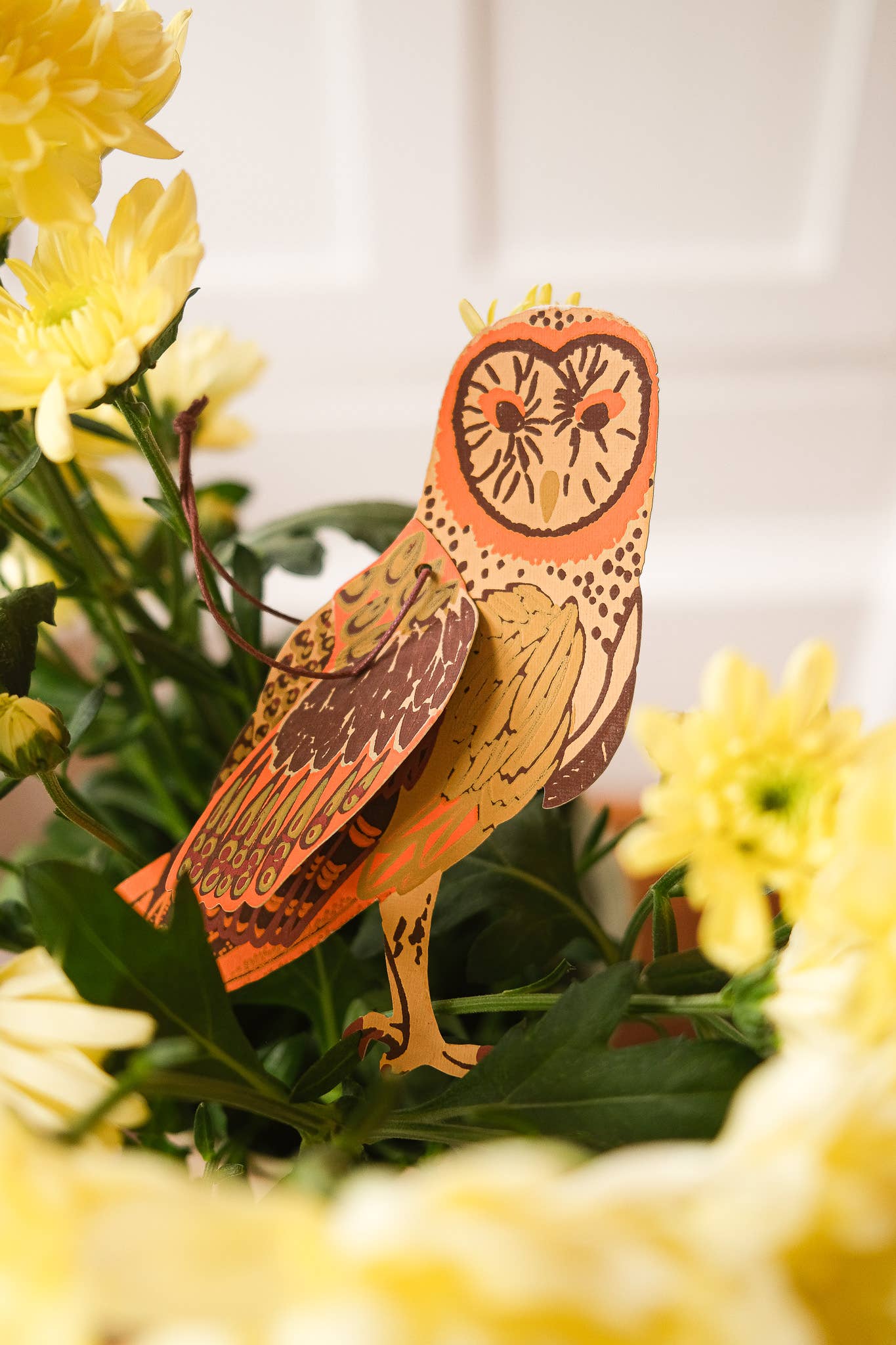 Hand screen-printed Winter Birds Paper Ornaments hanging, showcasing recycled material