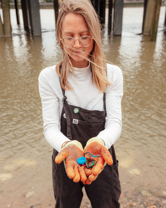 Washed Up Cards founder collecting microplastics on a UK beach for greeting cards